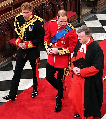 Prince William, and his brother and best man Prince Harry (L) and Stephen Lamport, Receiver General of the Abbey (R), arrive at Westminster Abbey