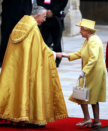 Queen Elizabeth II greets The Right Reverend Dr John Hall, Dean of Westminster as she arrives to attend the royal wedding at Westminster Abbey