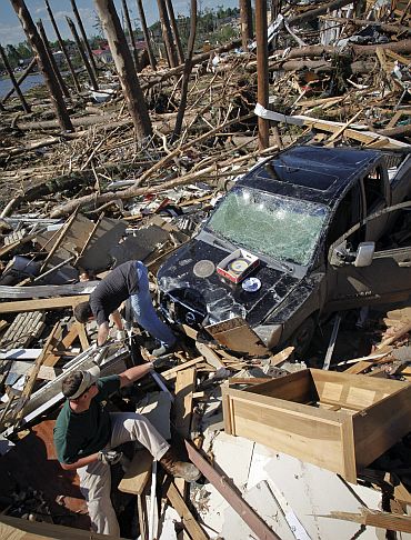 Residents salvage belongings in the aftermath of deadly tornados in Tuscaloosa, Alabama