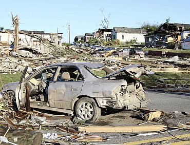 The aftermath of overnight tornadoes show destroyed homes and vehicles in Pratt City, a suburb of Birmingham, Alabama