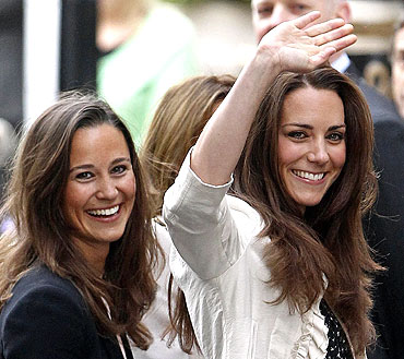 Kate Middleton, the fiancee of Britain's Prince William, waves as she arrives with her sister Pippa