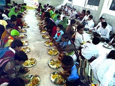 Students at Basu's school share a meal