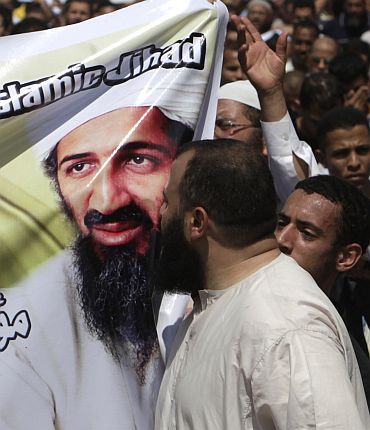 A man kisses a picture of Osama bin Laden during a protest in Cairo