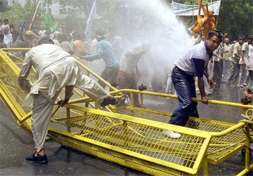 Police use water cannons to disperse protestors during a protest rally by Dalits