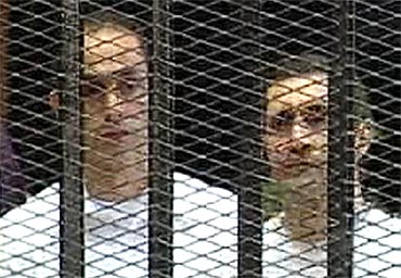 Gamal and Alaa Mubarak in the courtroom during their trial at the police academy in Cairo