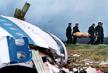 File photo shows rescue personnel carrying a body away from the site of the Lockerbie