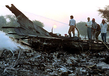 A fireman hoses down the smouldering wreckage of a Saudi Arabian jumbo jet after it crashed outside the Charkhi Dadri village after colliding with a Kazakh cargo plane.