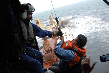 Coast Gaurd official airlifts a crewmember