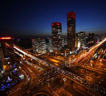 Vehicles drive on Three Ring Road (left) and Jianwai Street (right) during the evening rush hour in central Beijing