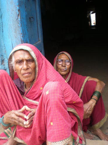 Elderly women listen to an election speech in Maharashtra