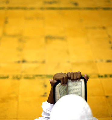A student reads the Koran before morning prayer at the Al-Mukmin Islamic boarding school in Solo, Indonesia