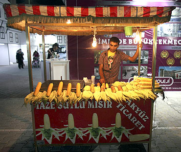 A vendor, selling corn, waits for customers after iftar in Beylikduzu, a district of Istanbul