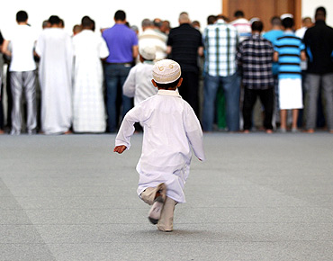 A young boy runs to take part in a prayer at Strasbourg's new Grand Mosque