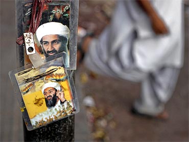 Images of Al Qaeda leader Osama bin Laden are displayed for sale at a roadside shop in Karachi