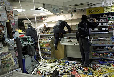 Looters rampage through a convenience store in Hackney, east London
