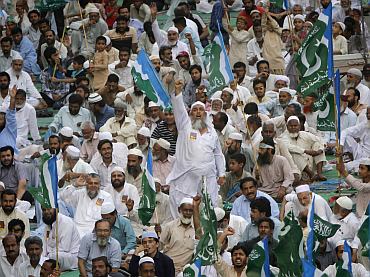 A supporter of the religious and political party, Jamaat-e-Islami, shouts slogans as hundreds gather to protest against drone attacks, in Karachi