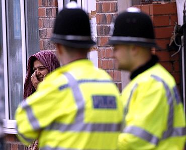 A woman reacts at the scene where three men were killed by a car in Winson Green area of Birmingham, central England