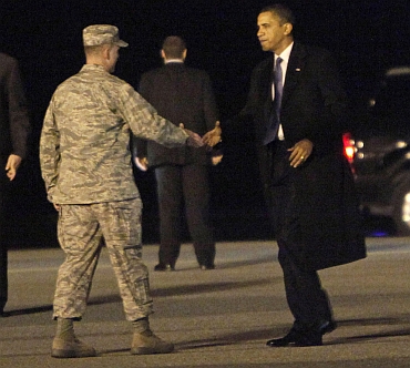Obama is greeted by Air Force Col Manson Morris as he steps off Marine One at Dover Air Force Base