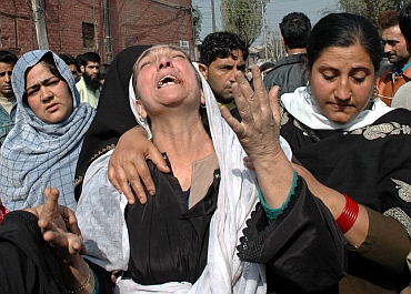 A Kashmiri relative cries during a protest against the conviction of Nazir Ahmad and his son Farooq Ahmad on October 26, 2005