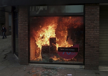 A clothing store is seen ablaze in Manchester city centre, northern England