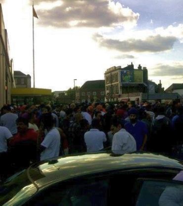 Sikhs gather outside the gurdwara in Southall