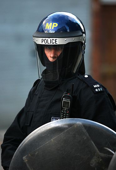 A riot police officer stands guard