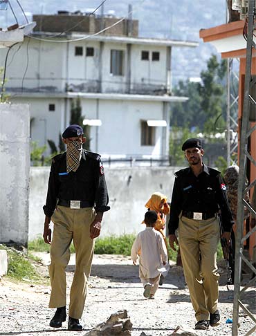 Pakistani policemen patrol a street near the compound where Al Qaeda leader Osama bin Laden was killed by US troops in Abbottabad