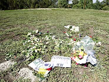 Flowers and candles are placed at a park in memory of Nitin Garg, who was stabbed and killed in Melbourne