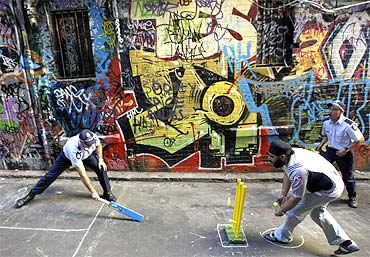 Indian students and policemen play a game of laneway cricket in Melbourne to promote harmony
