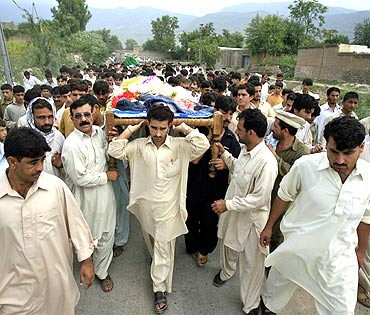 Men carry coffins of victims killed in a suicide bomb attack in Kohat in northwestern Pakistan