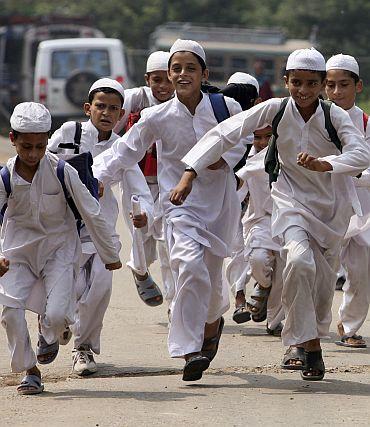 Boys run home from a  madrassa on the outskirts of Jammu