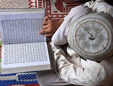 A boy reads the Quran at a madrassa in Mathura