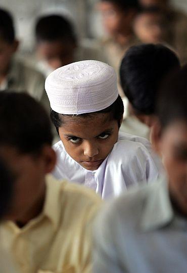 A madrassa student reads the Quran