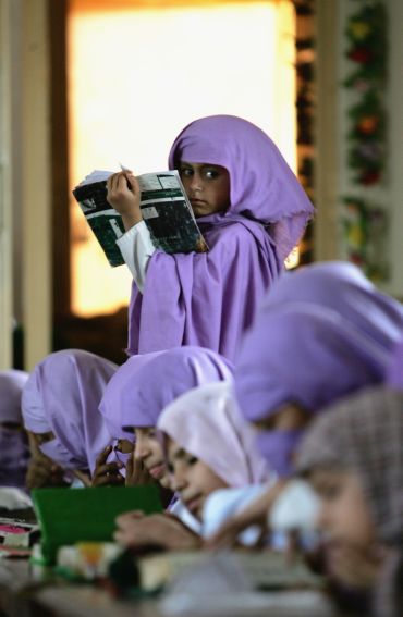 Female madrassa students study the Quran