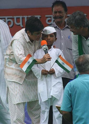 Kiran Bedi with a school kid on stage
