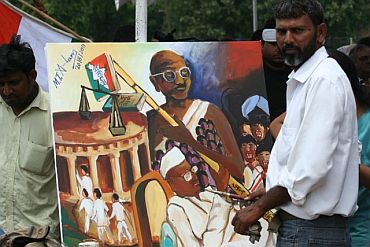Painter Mohammed Tabrez Alam from Gaya with his paintings at the Ramlila Ground in New Delhi