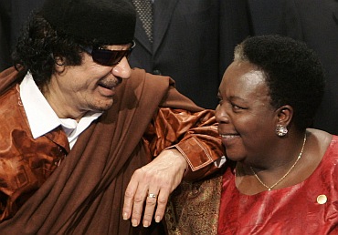 Libya's Colonel Muammar Gaddafi with Pan African Parliament President Gertrude Mongella from Tanzani