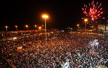 Fireworks explode as people gather near the courthouse in Benghazi