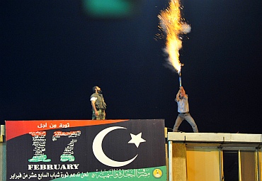A man lets off fireworks near the courthouse in Benghazi