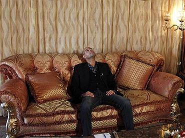 Libyan leader Muammar Gaddafi's most prominent son, Saif al-Islam, pauses during an interview with Reuters in Tripoli March 10