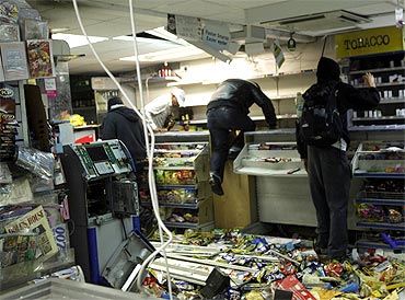 Looters rampage through a convenience store in Hackney, east London