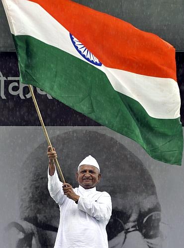 Social activist waves the tricolour during his indefinite fast to press for a stronger Lokpal Bill at Ramlila Ground in Delhi