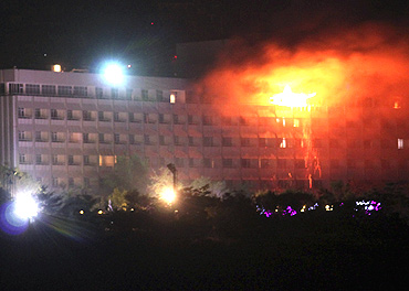 Smoke and flames rise from the Intercontinental hotel during a battle between NATO-led forces and suicide bombers and Taliban insurgents in Kabul on June 29