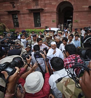 Anna Hazare and Arvind Kejriwal wave to the media after a joint Lokpal drafting committee meeting in New Delhi