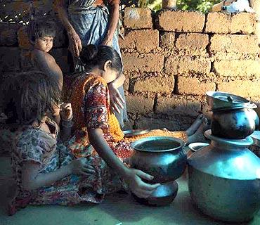 Gulabi cries in her kitchen, overwhelmed by her circumstances