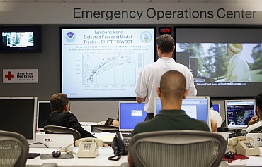 Officials at the American Red Cross in Greater New York Emergency Operations Center discuss their preparations for the landfall of Hurricane Irene in New York