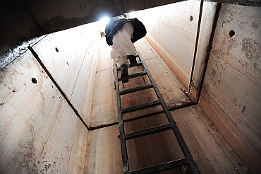 A Libyan man climbs a ladder to exit the extensive underground tunnels running under the summer residence of Libya's leader Muammar Gaddafi's at Cyrene near the Beydah