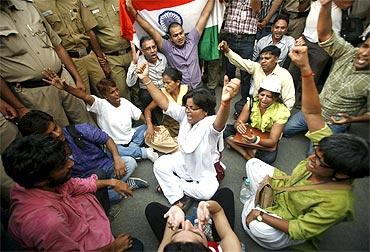 Supporters of Anna Hazare shout slogans outside the residence of Prime Minister Manmohan Singh