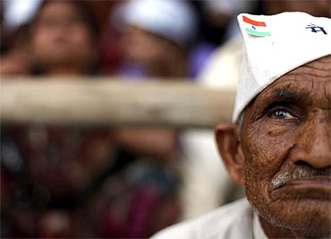 A supporter of Anna Hazare listens to the activist's speech at Ramlila Maidan