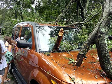 A tree lies on a vehicle in West Hempstead after being blown down by the winds of Hurricane Irene